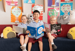 Three students at Our Lady of the Sacred Heart School Randwick reading in the library