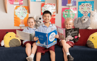 Three students at Our Lady of the Sacred Heart School Randwick reading in the library